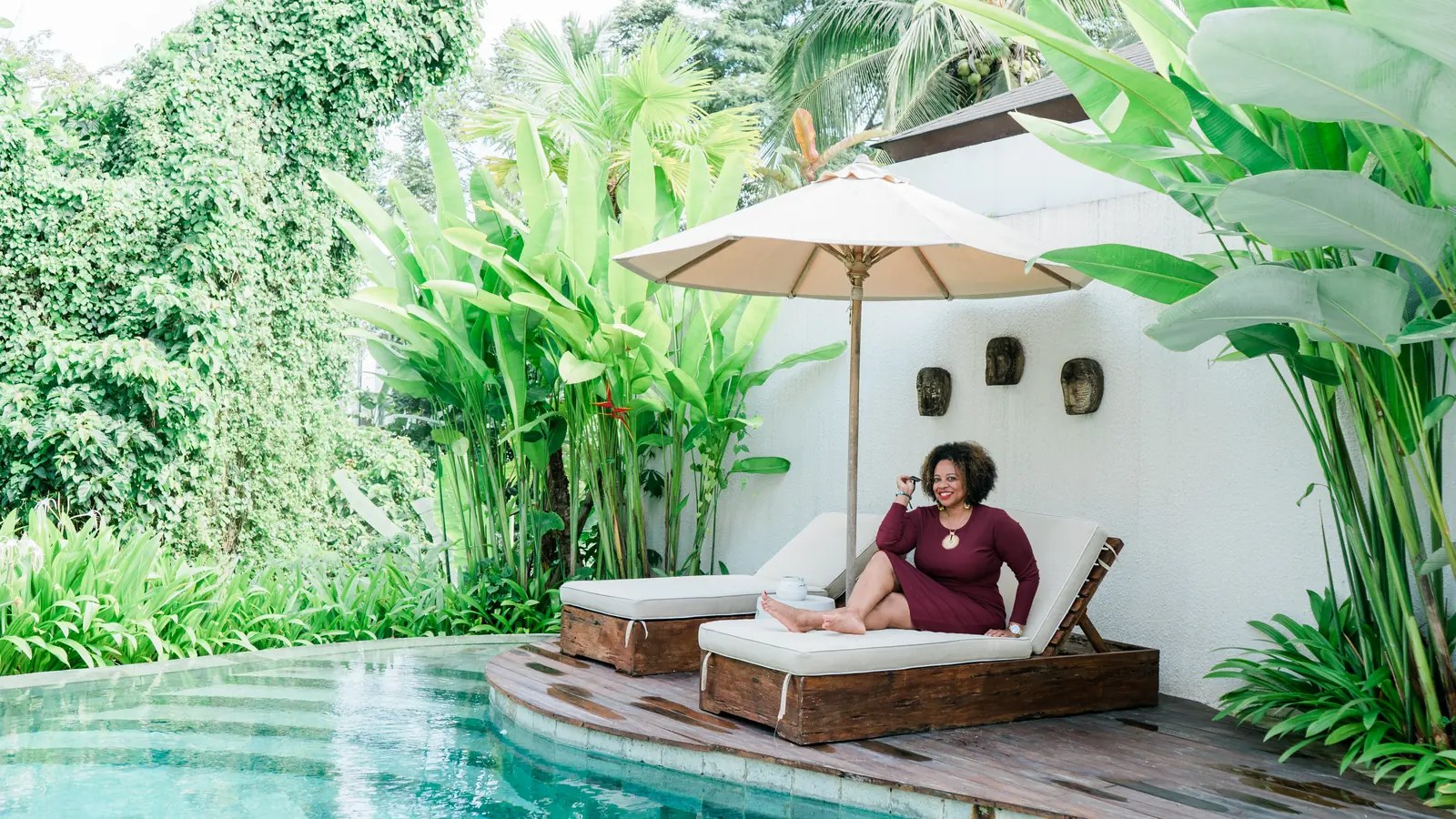 Claire on a poolside daybed at a private villa in Bali